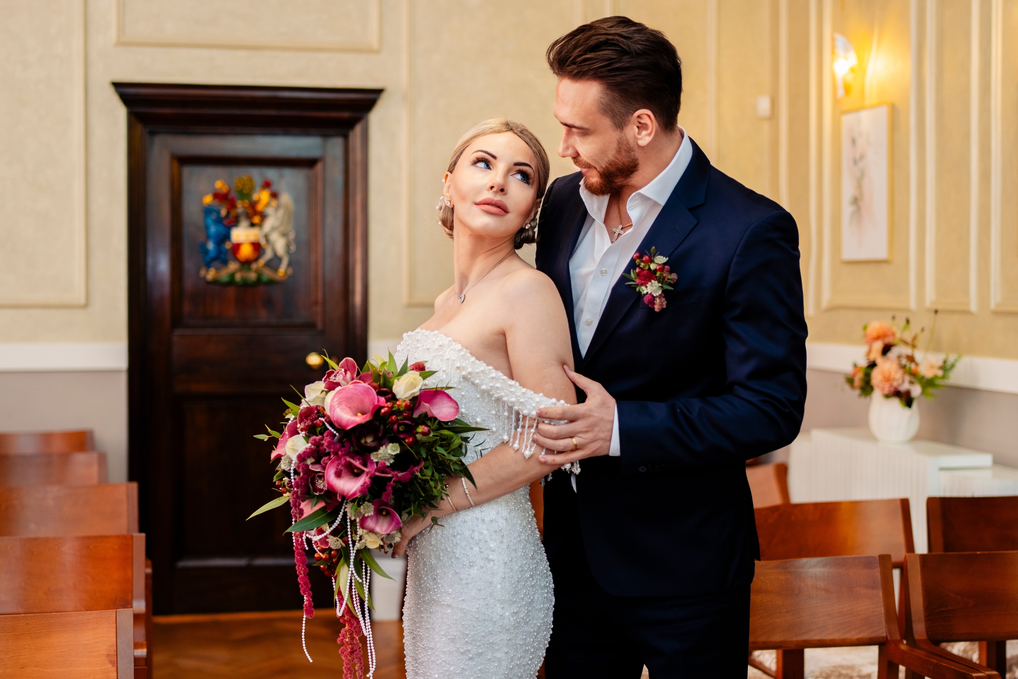 A tender portrait of the bride and groom captured gracefully indoors.
