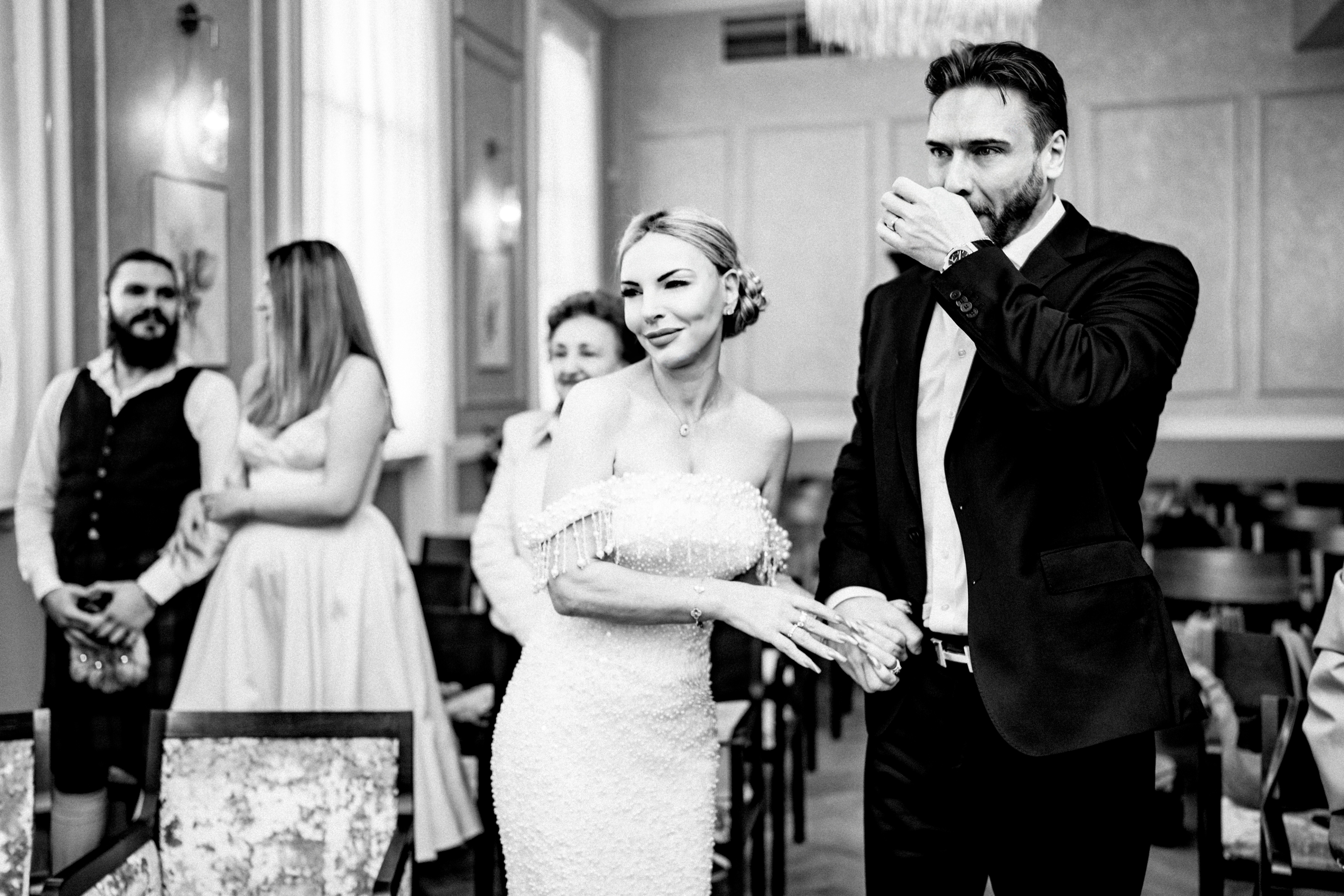 The stylish couple stands together during their intimate civil ceremony.